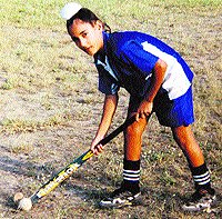 Young Jasjit Kular with his hockey stick