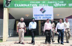 Officials come out of a counting centre on the PAU campus in Ludhiana on Thursday