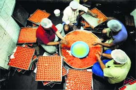 Workers prepare laddoos at the workshop in Ludhiana