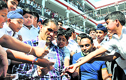 Students jostle for wrestler Khalis signature at DAV school in Jalandhar on Thursday