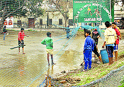 A group of young hockey players preparing the small hockey field where the legends from Sansarpur took their first lessons in the sport