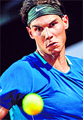 Rafael Nadal returns a ball to Frances Gilles Simon during the third round match of the Rome Masters
