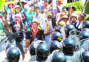Thai anti-government protesters face off with army men as they storm the Air Force auditorium in Bangkok.