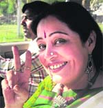 Party candidate Kirron Kher flashes the victory sign.