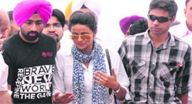 Aam Aadmi Party candidate Gul Panag comes out of the counting centre along with her brother (in turban) after the declaration of the results at Sector 26 in Chandigarh on Friday.
