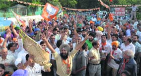 BJP supporters in a jubilant mood at the party office in Chandigarh on Friday.