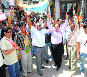 BJP workers and supporters celebrate at the Nehru Chowk in Kangra on Friday. 