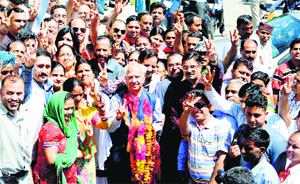 Shanta Kumar celebrates with party workers after winning the MP election at Dharamsala on Friday. 
