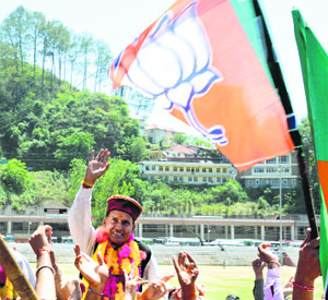 BJP candidate Ram Swaroop Sharma takes out a victory procession in Mandi on Friday.