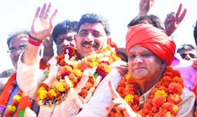BJP candidate Jugal Kishore Sharma waves at his supporters after coming out of a counting centre in Jammu on Friday.