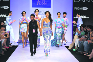 Ken Ferns walks the ramp with models in his creations