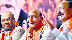 BJP chief Rajnath Singh with party leaders Amit Shah (L) and Venkaiah Naidu in New Delhi