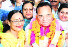 Congress candidate Chaudhary Santokh Singh with his wife Karamjit Chaudhary in Jalandhar on Friday.