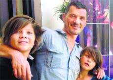 Marcus Schmid flanked by his children. Photo: Pradeep Tewari