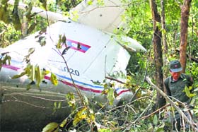 A rescue worker makes his way past the wreckage of an air force plane at its crash site near Nadee village on Saturday