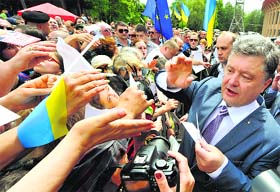 Ukrainian businessman, politician and presidential candidate Petro Poroshenko (R) meets his supporters during his election rally in the city of Krivyi Rih on Saturday