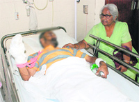 Manmohan Kaur, mother of the victim (face blurred), sits by his side at the Command Hospital in Panchkula on Sunday.