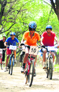 Cyclists take part in the Chandigarh Mountain Biking Championship on the Sukhna wildlife trail behind the lake on Sunday