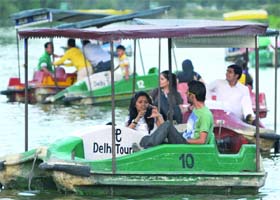 Holiday-makers make the most of balmy weather at Boat Club near India Gate in New Delhi on Sunday