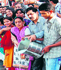 BJP activists offer milk to the Ganga in Haridwar on Sunday to express their gratitude for the victory of Ramesh Pokhriyal Nishank by a record margin