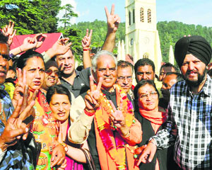 Varinder Kashyap, BJP candidate from the Shimla constituency, celebrates his victory with supporters in Shimla.