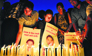A candlelight march being organised by kin of local industrialist Chandar Mohan Arora outside the Railway police station in Jalandhar on Sunday.