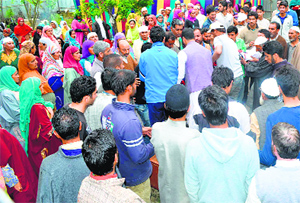 Relatives mourn the death of the youth in Sopore on Sunday.