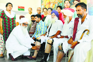 Differently abled persons get artificial limbs at Viklang Sahayta Kendra in Ludhiana on Sunday.