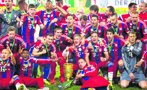 Bayern Munich celebrate with the trophy after winning the German Soccer Cup final against Borussia Dortmund (2-0) at the Olympic Stadium in Berlin, on Saturday. 