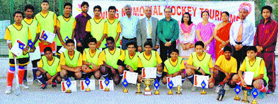 The winning team with the trophy at Oak Grove School ground at Jharipani in Mussoorie on Monday. A Tribune photograph