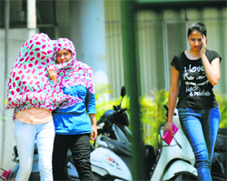 Girls protect themselves from the scorching sun in Ludhiana.