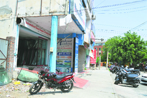 The corridor outside shops encroached upon by building walls and staircases at the main market in Kitchlu Nagar, Ludhiana
