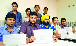 Office-bearers of the NGO Action Against Corruption show a copy of Modi Chalisa issued by the BJP activists in Ludhiana. 