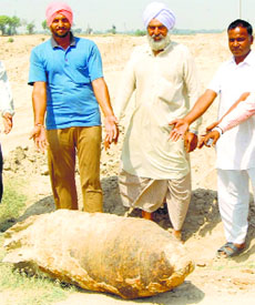 Pakka Chisti villagers show the live bomb.