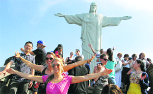 Fans pose for picture in front of the famous Christ the Redeemer monument atop of Corcovado mountain in Rio de Janeiro.