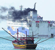 A ship carrying Chinese workers leaves Vung Ang port on Monday.