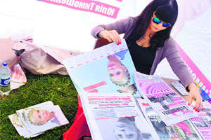 A supporter of Ukrainian presidential candidate Yulia Tymoshenko prepares calendars with her portraits in Lviv on Monday.