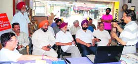 Members of the Hall Bazar Traders Association hold a meeting in Amritsar on Tuesday.