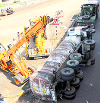 A JCB machine removes the tanker that overturned at Majri Chowk in Panchkula on Tuesday morning