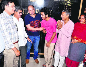 The police hand over the rescued student to his family members in Rohtak on Tuesday. 
