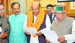 Vidhan Sabha Speaker Brij Bihari Lal Butail administers oath to Narinder Thakur as MLA in Shimla on Tuesday. 
