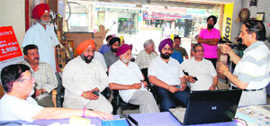 Members of the Hall Bazar Traders Association hold a meeting in Amritsar on Tuesday.