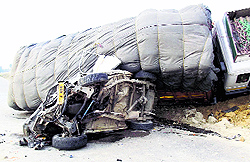 The mangled remains of Sumo taxi on which a loaded truck overturned at Awantipora in Anantnag district on Tuesday
