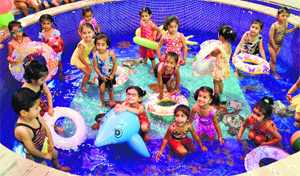 Tiny tots of Greenland School enjoy during a pool party held on the school premises on Tuesday.