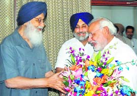 Punjab CM Parkash Singh Badal and his Deputy Sukhbir Singh Badal with PM-designate Narendra Modi at Gujarat Bhawan in New Delhi on Tuesday.