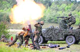German soldiers fire mortars during JAWTEX 2014 (Joint Air Warfare Tactical Exercise) at an army training area in Bergen. About 4,500 soldiers from 11 nations are taking part in the years largest European military exercise.