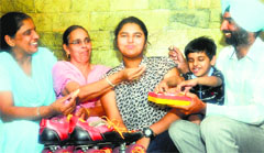 Sirjana is all smiles with her family members at their residence in Phase X, Mohali, on Wednesday. Tribune Photo