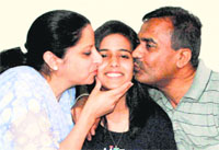 Malvi Paul in a jubilant mood with her parents at their residence in Phase 3B1, Mohali, on Wednesday. A Tribune Photo