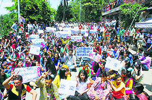 SFI activists stage a protest on the HPU campus in Shimla on Wednesday