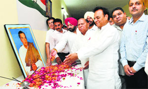 Congress MP Chaudhary Santokh Singh and his brother Chaudhary Jagjit Singh pay tributes to Rajiv Gandhi on his death anniversary at the Congress Bhawan in Jalandhar on Wednesday. 